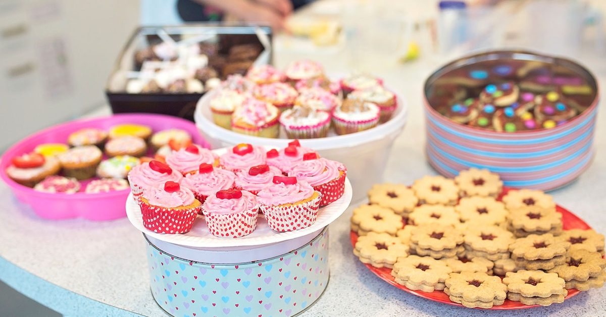 Colourful bake sale display with cupcakes and cakes