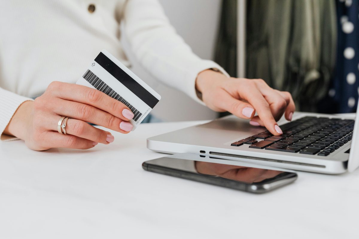 Person shopping online with a laptop and credit card