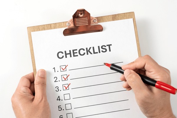 Person ticking off items on a checklist