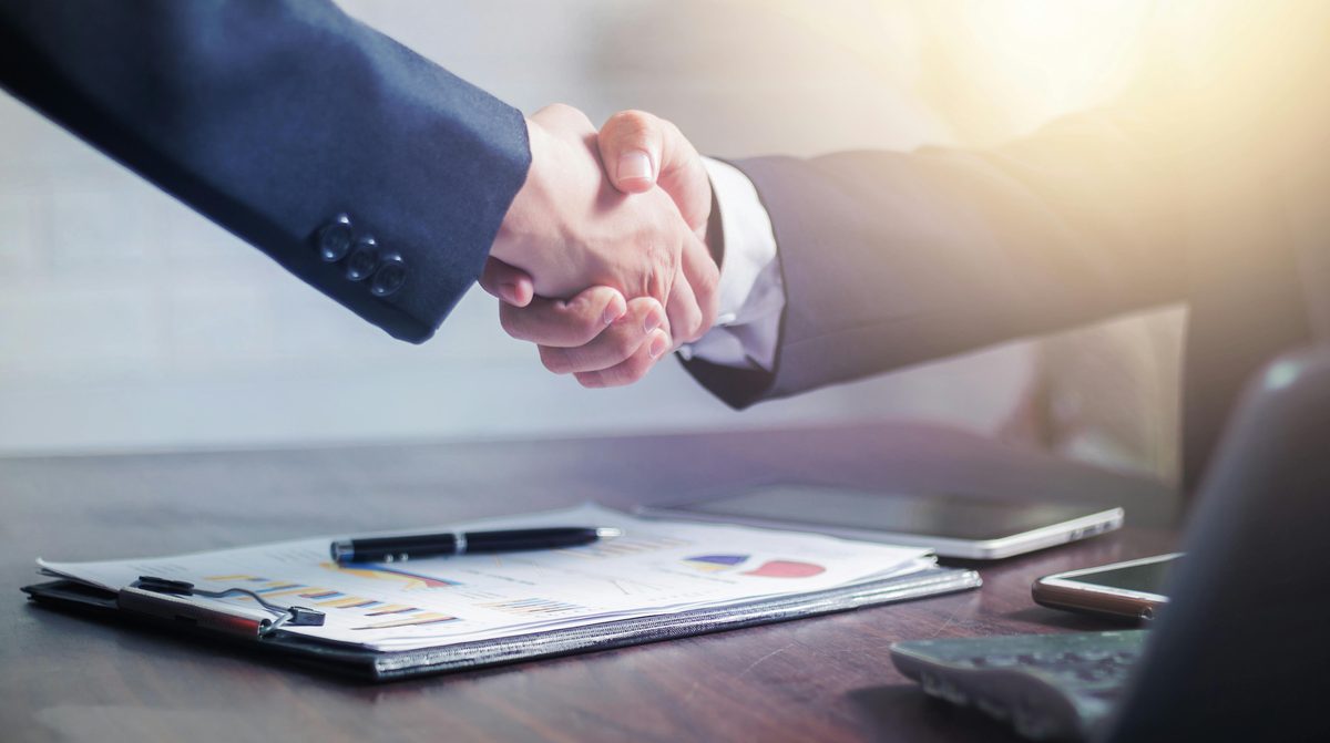 Business handshake representing corporate sponsorship