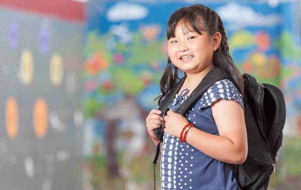 A teenager smiling while wearing an expedition backpack