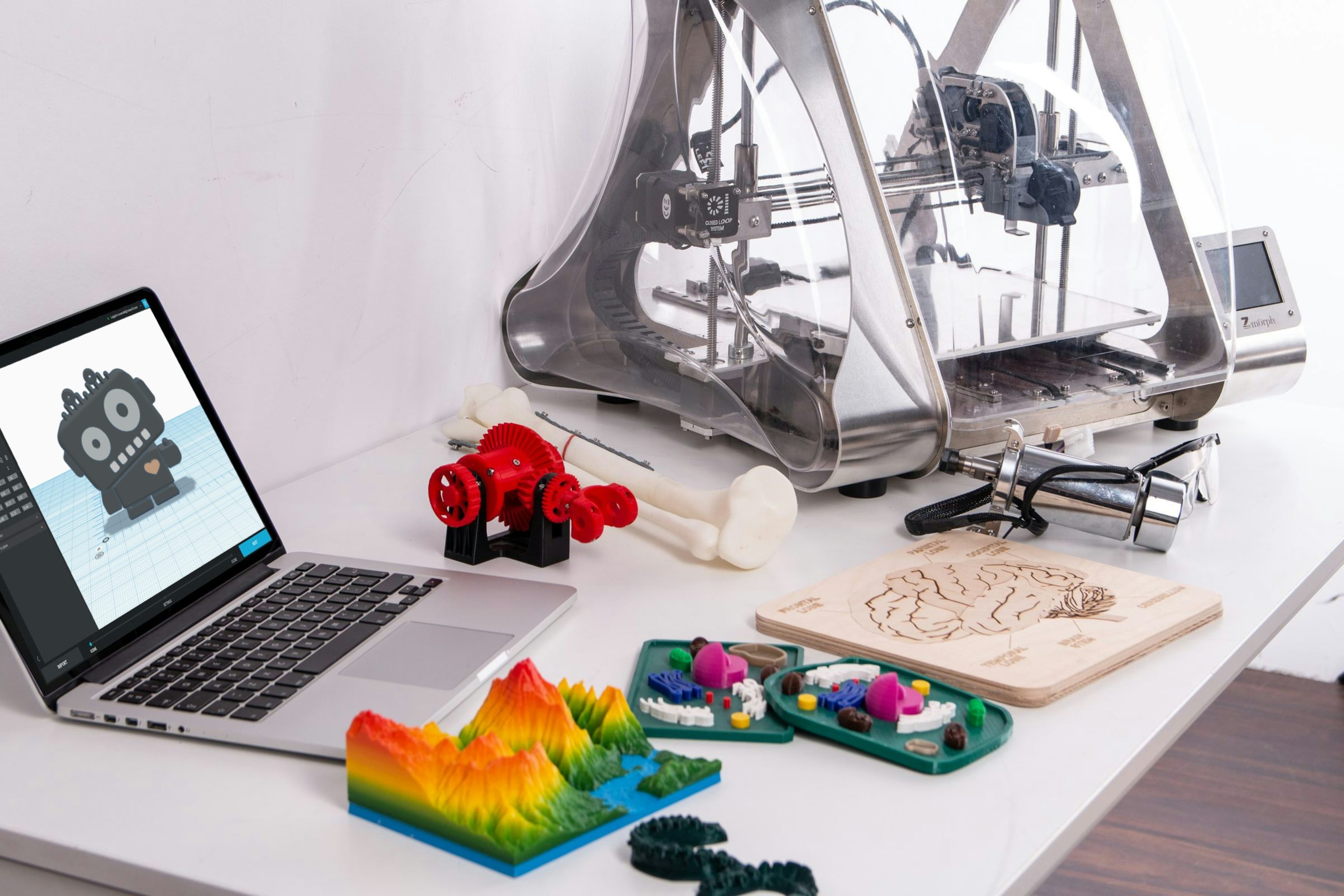 A desktop 3D printer with small printed toys, illustrating a 3D-printing business