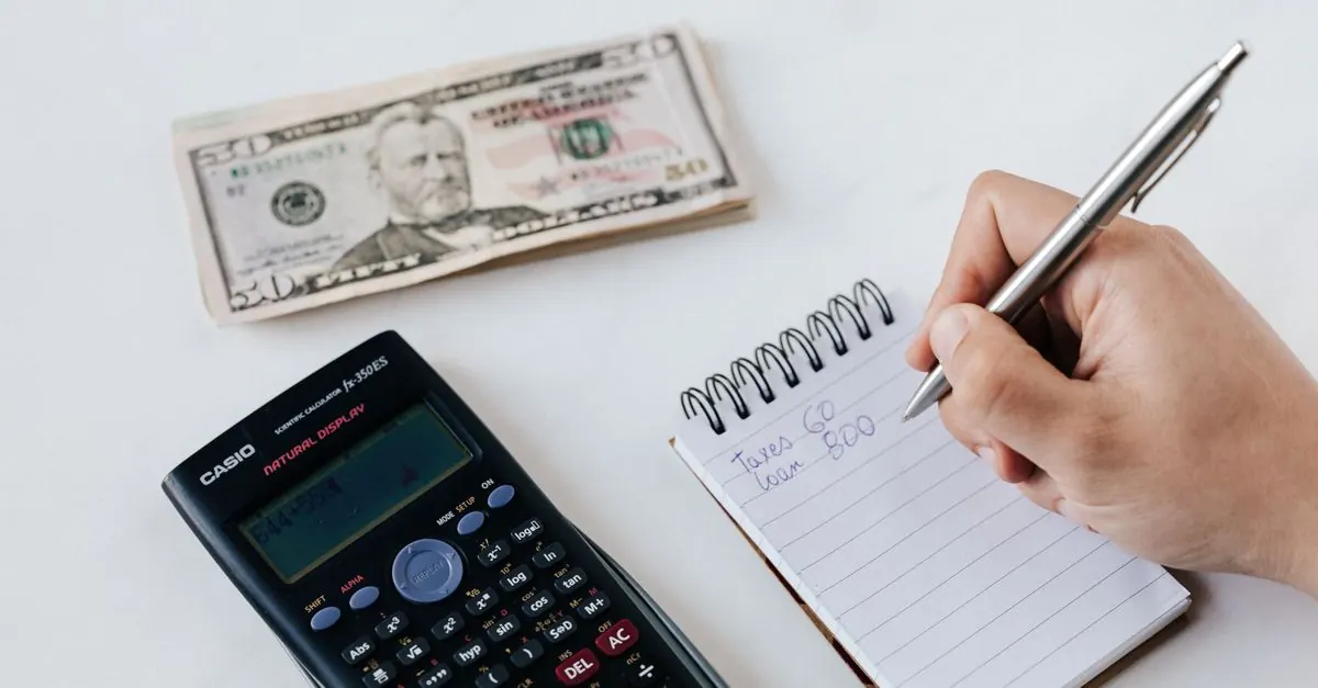 A notebook and calculator used to plan a fundraising target