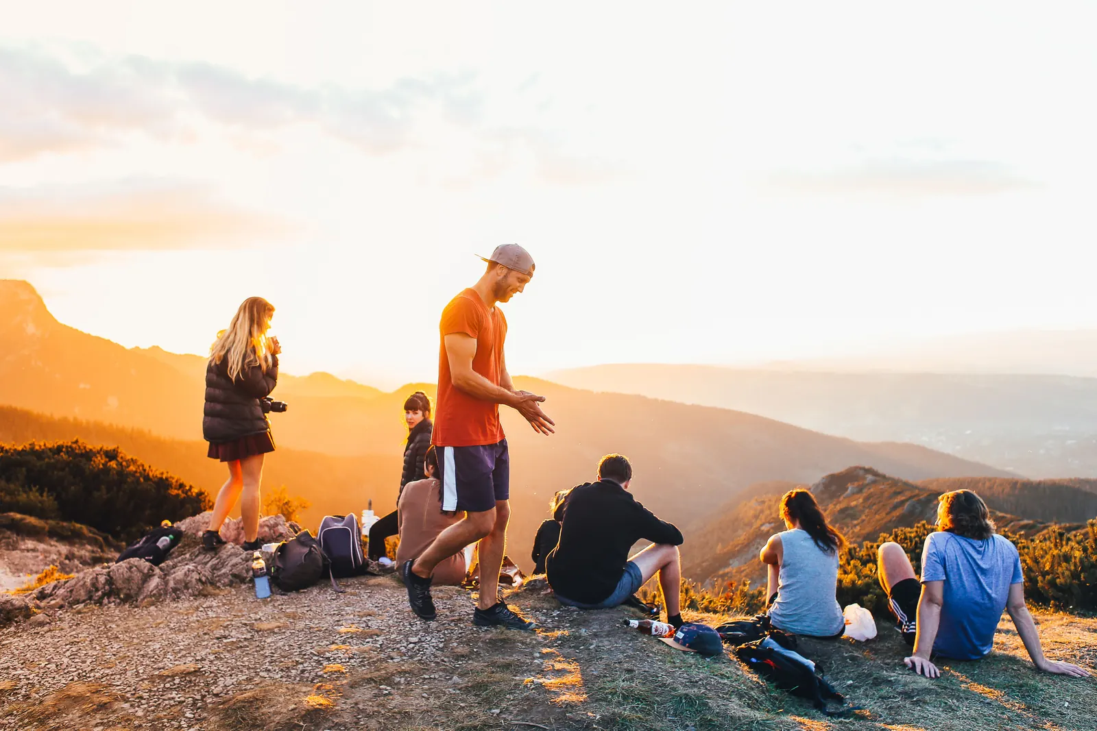 A group of young people standing together on a mountain during an outdoor adventure