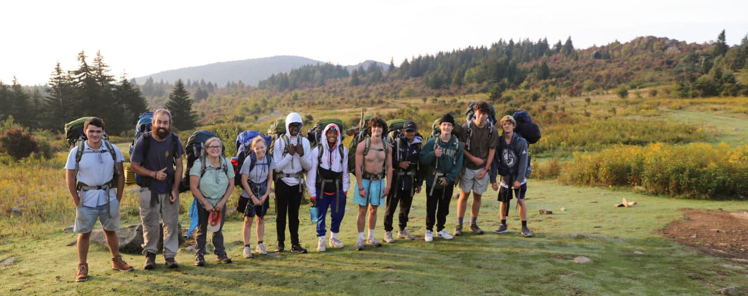 A Trip Leader supporting a group of young people on an outdoor adventure
